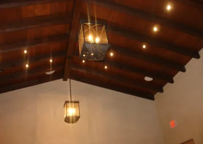 A wooden ceiling with lights hanging from it.